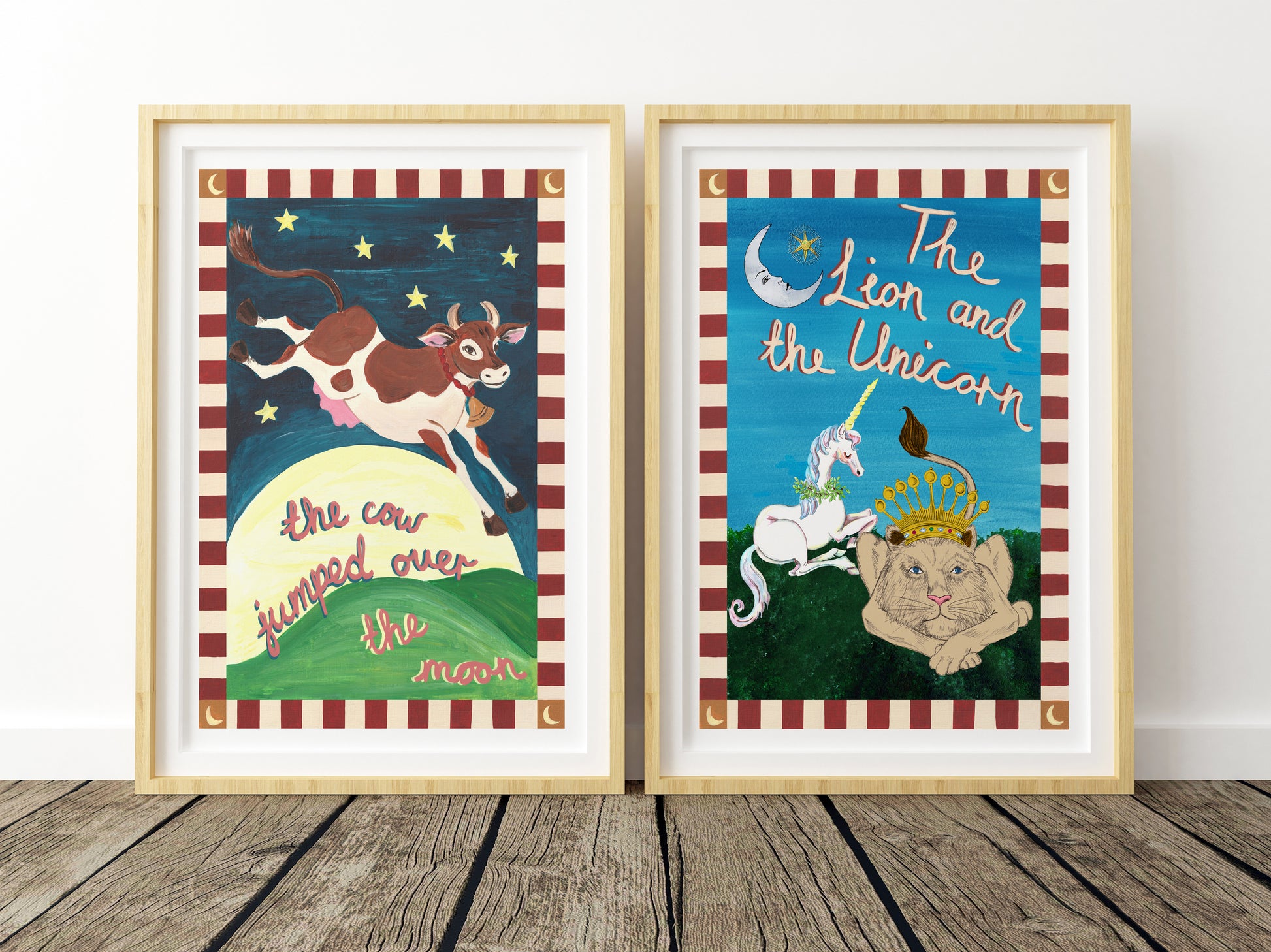 Two framed illustrations of 'The Cow Jumped Over the Moon' and 'The Lion and the Unicorn' on a wooden floor.