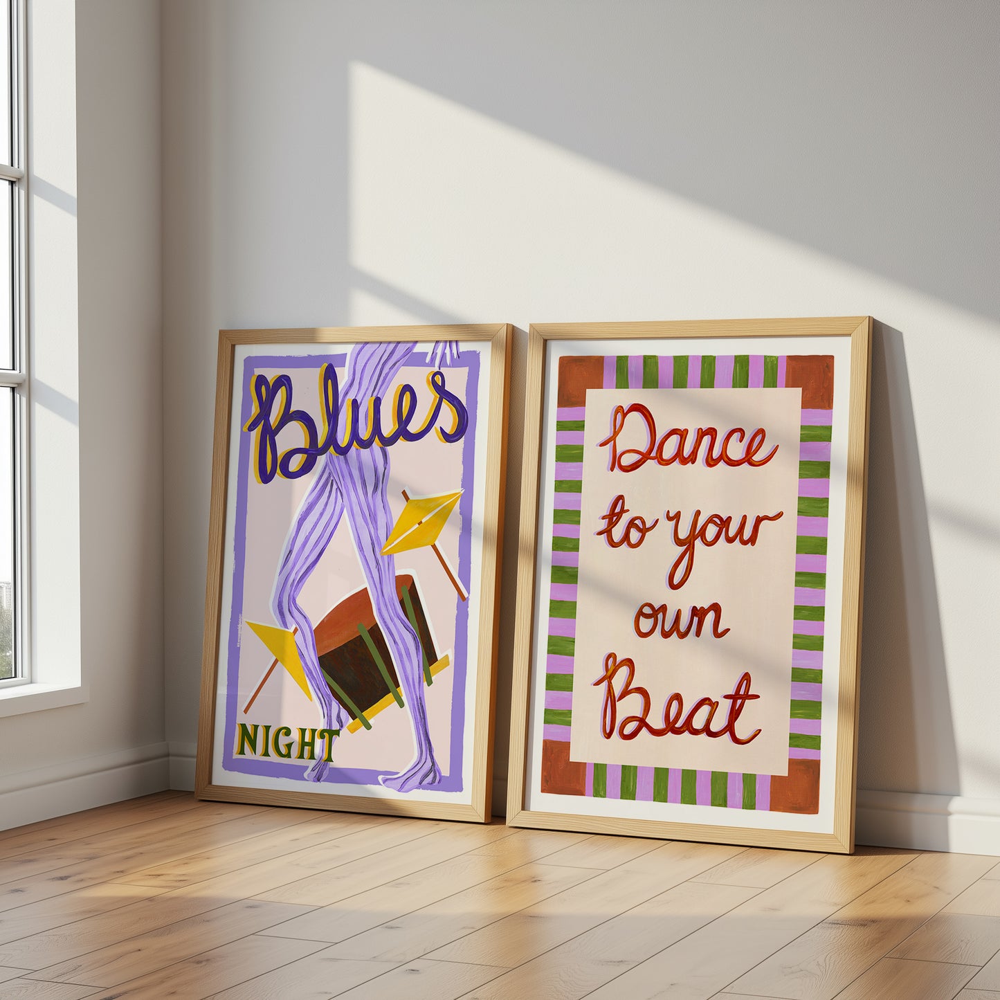 Two framed posters on a wall with 'Blues Night' and 'Dance to your own Beat' text.