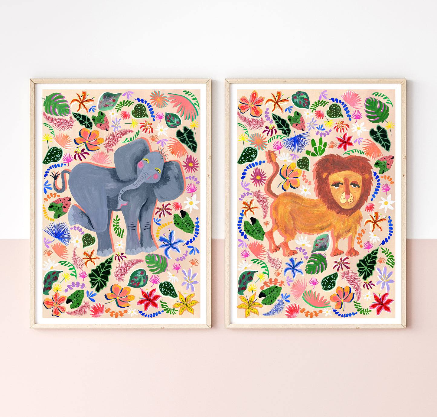 Two colorful animal prints of an elephant and a lion on a white wall.