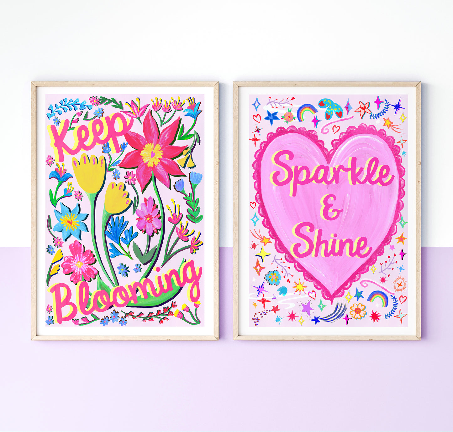Two colorful wall art prints with floral and heart designs on a white background.