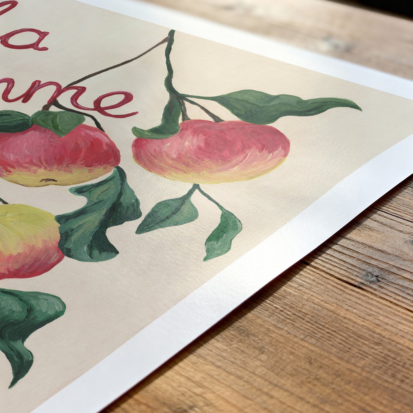Illustration of apples on a branch with leaves on a wooden surface