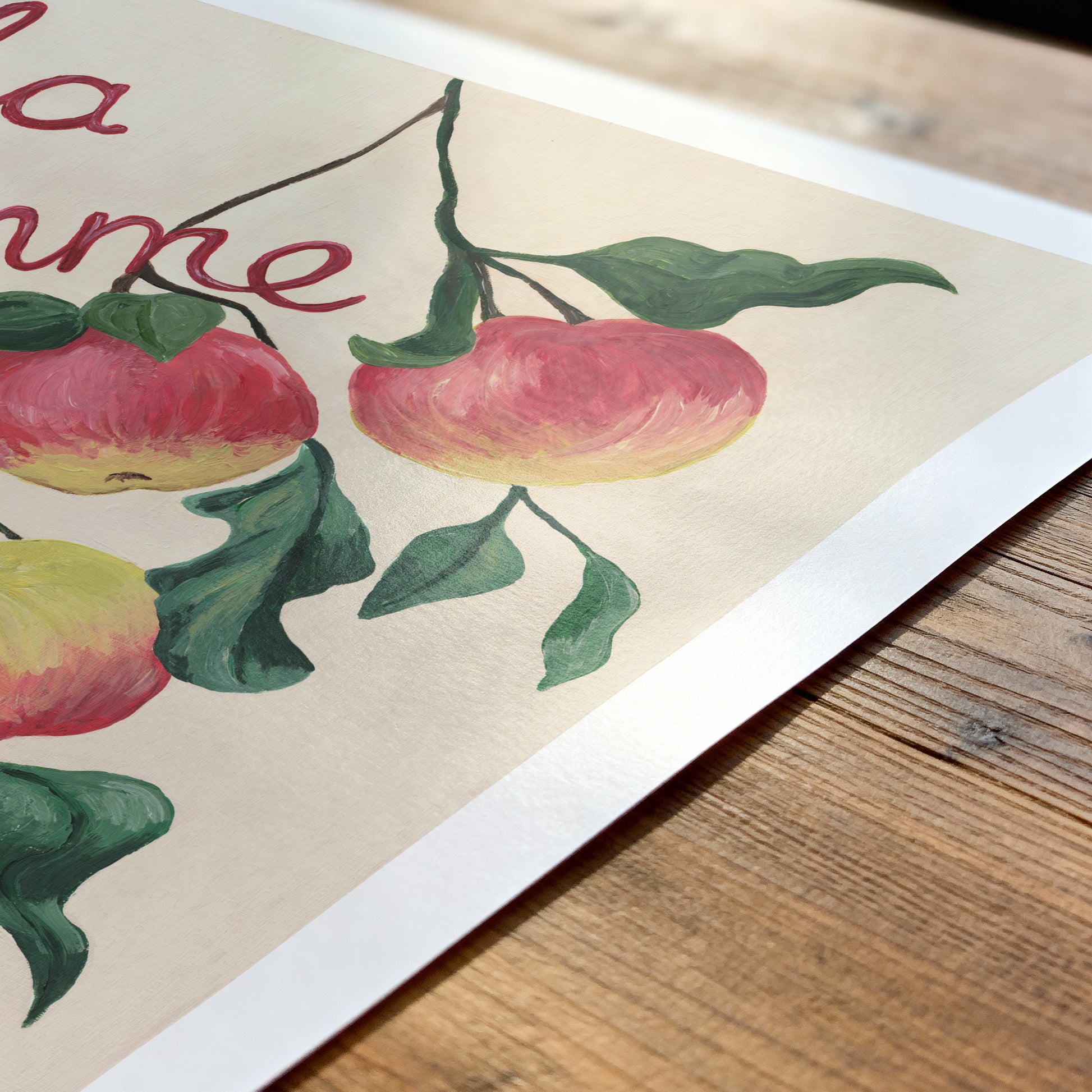 Illustration of apples on a branch with leaves on a wooden surface