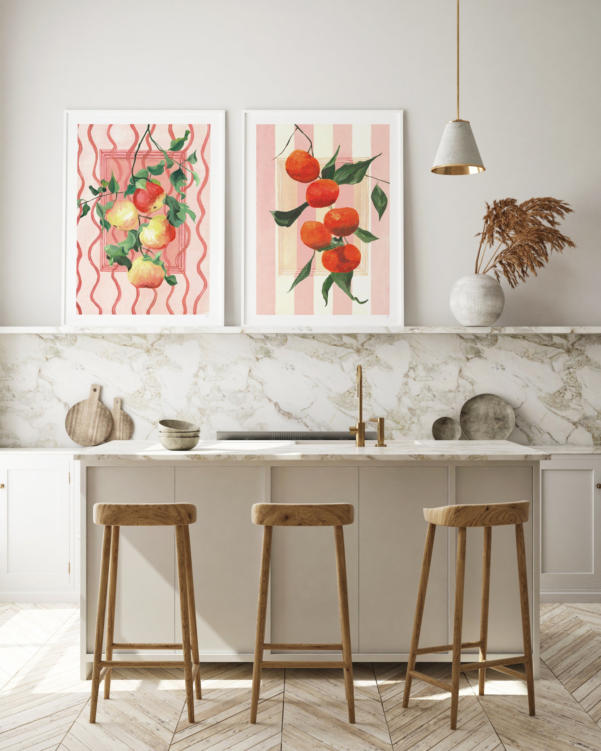 Kitchen interior with marble countertop, wooden stools, and decorative fruit prints on the wall.