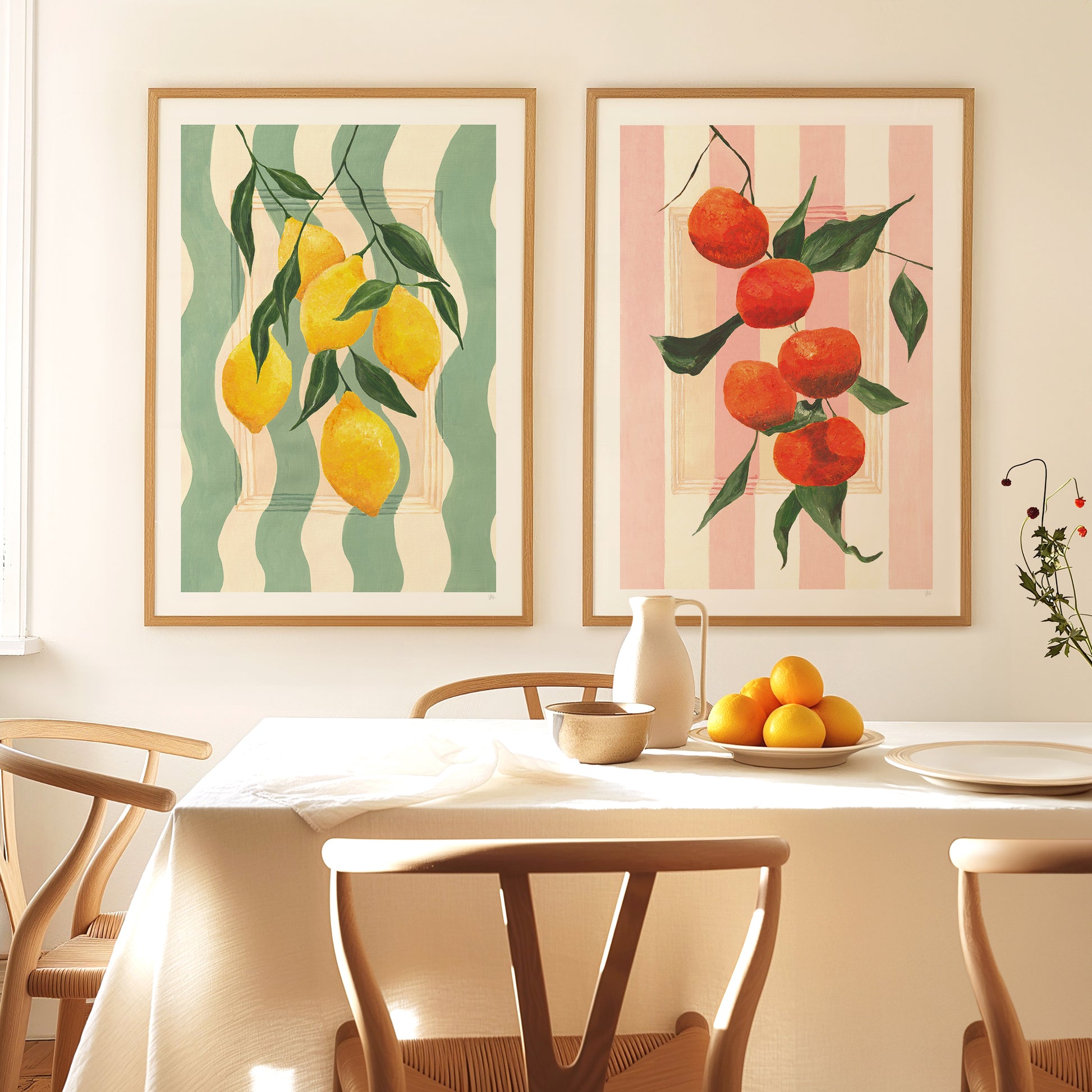 Dining room with fruit-themed wall art and a table set with fruit.