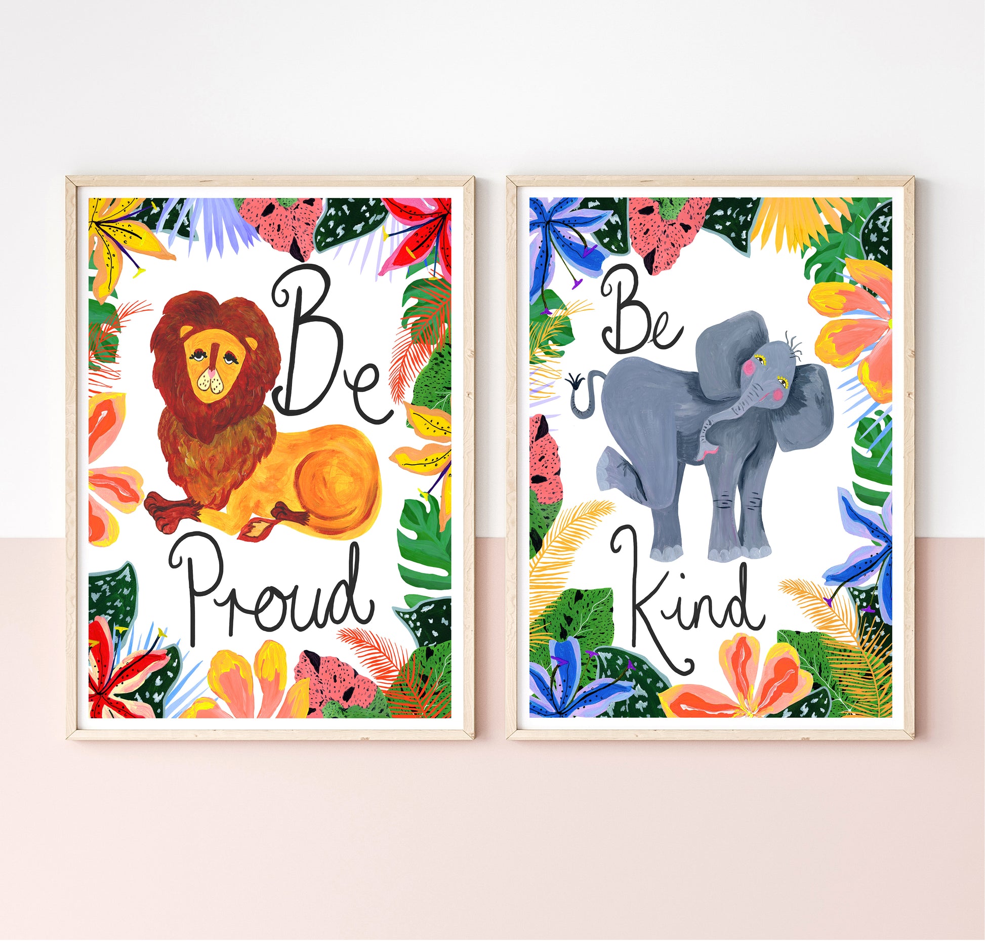 Two framed prints with a lion and an elephant, featuring motivational phrases and colorful foliage.