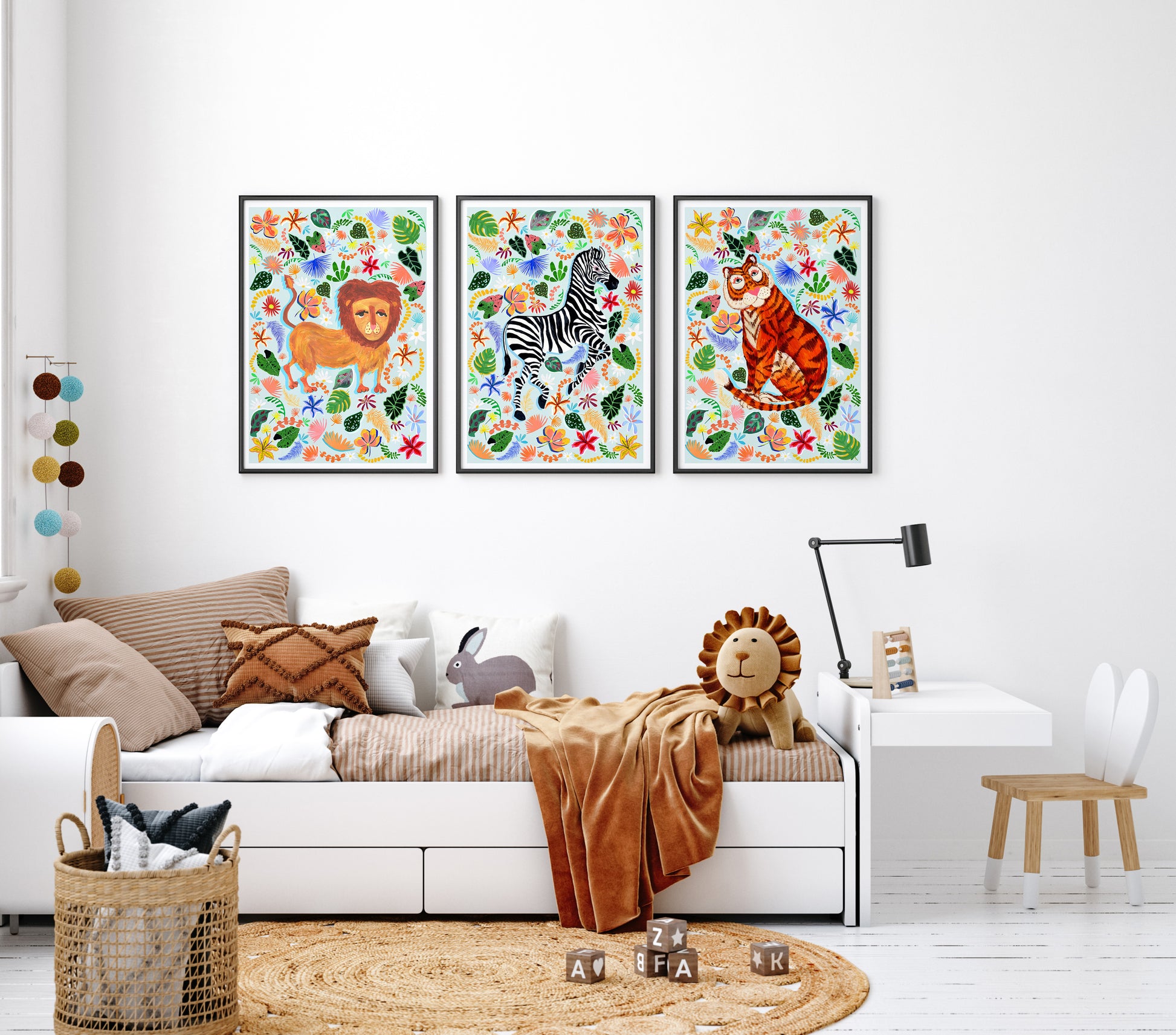 Children's room with colorful animal prints on the wall above a sofa.
