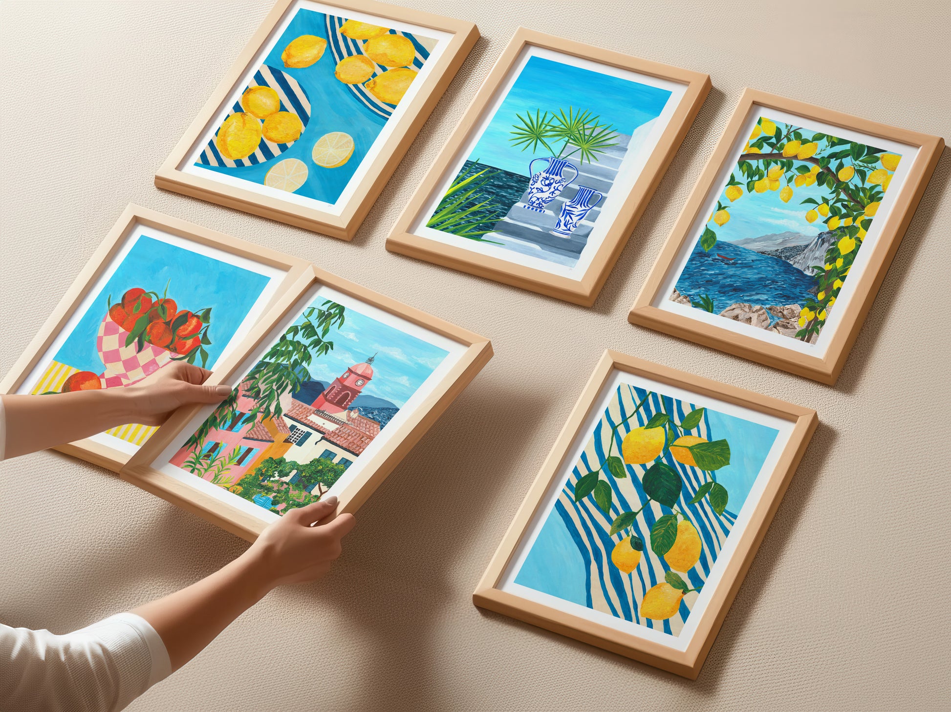 Framed artworks with scenic and nature-themed illustrations on a beige wall.
