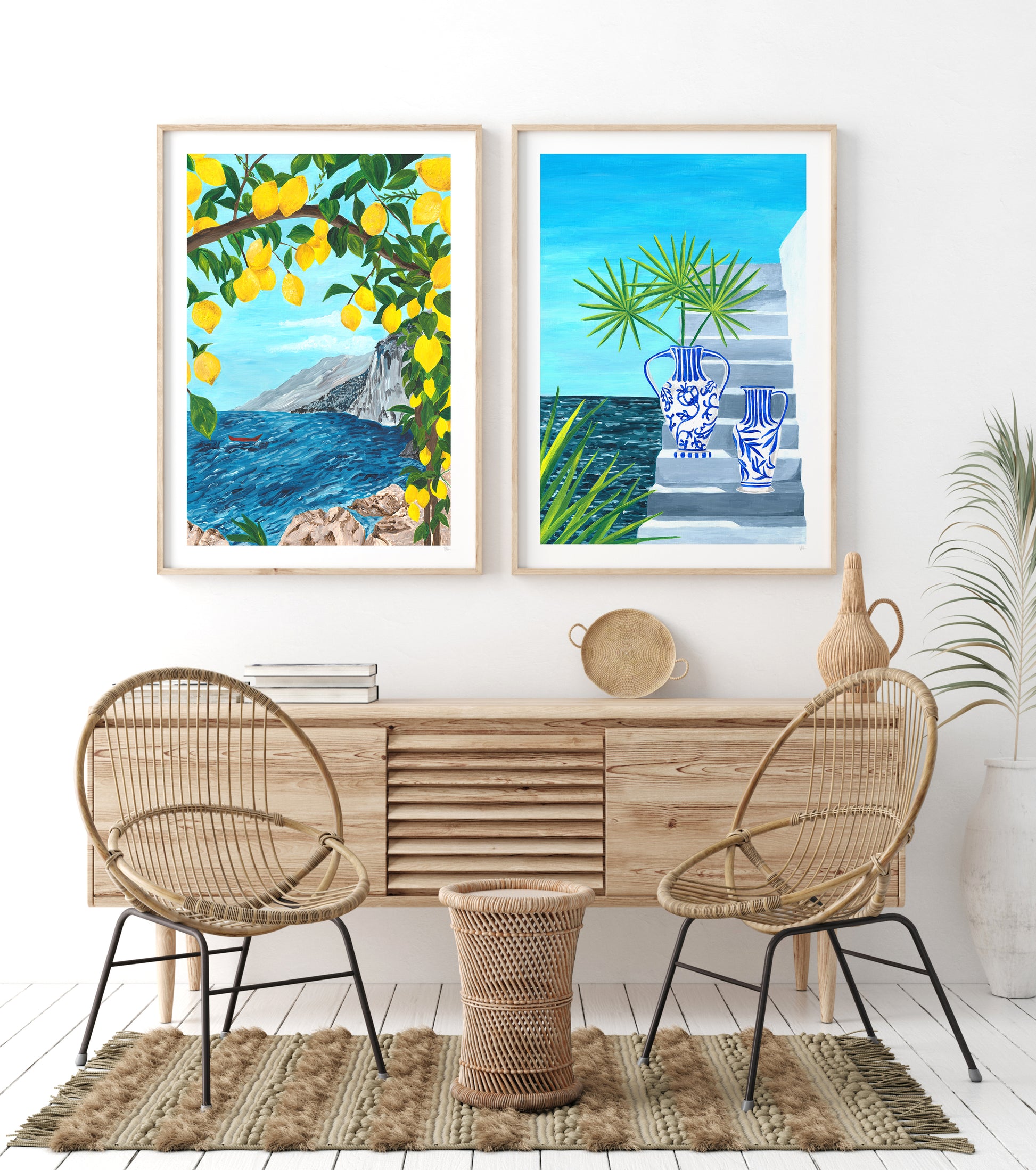 Modern interior with a wooden console table, wicker chairs, and framed artwork of lemons and a coastal scene.