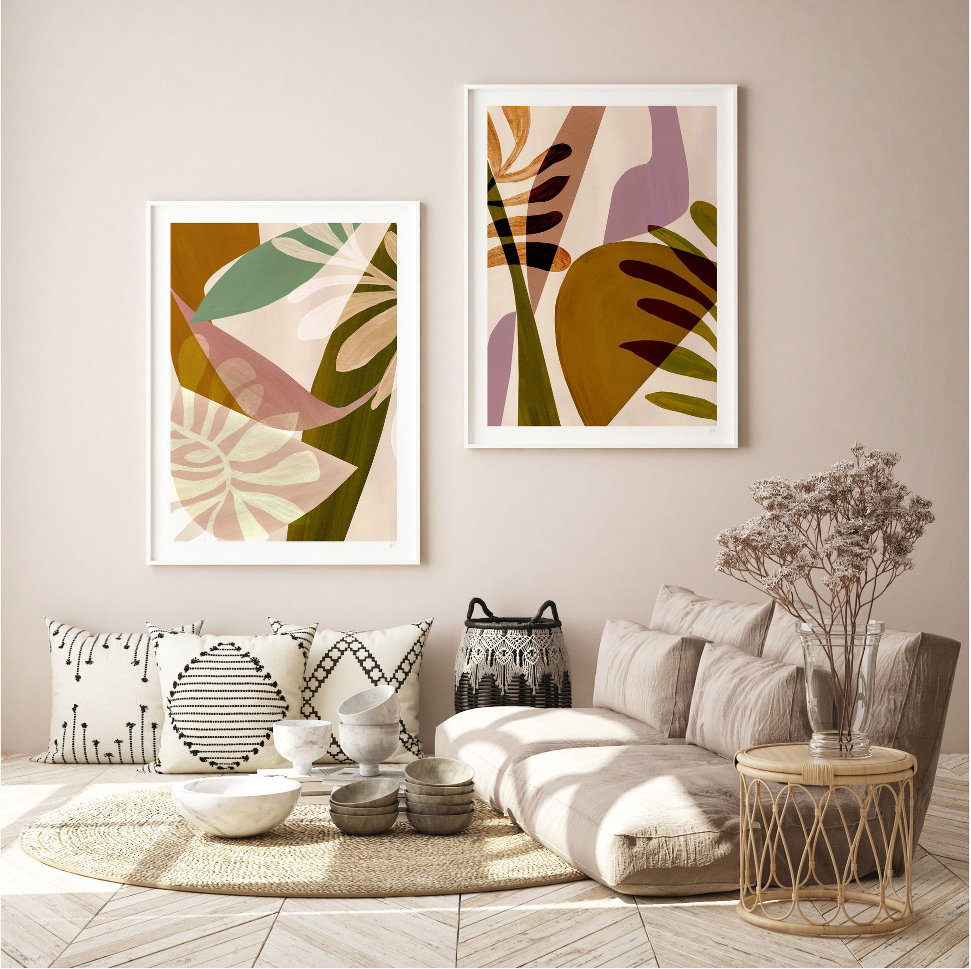 Living room with abstract leaf prints on the wall, a beige sofa, and decorative items.