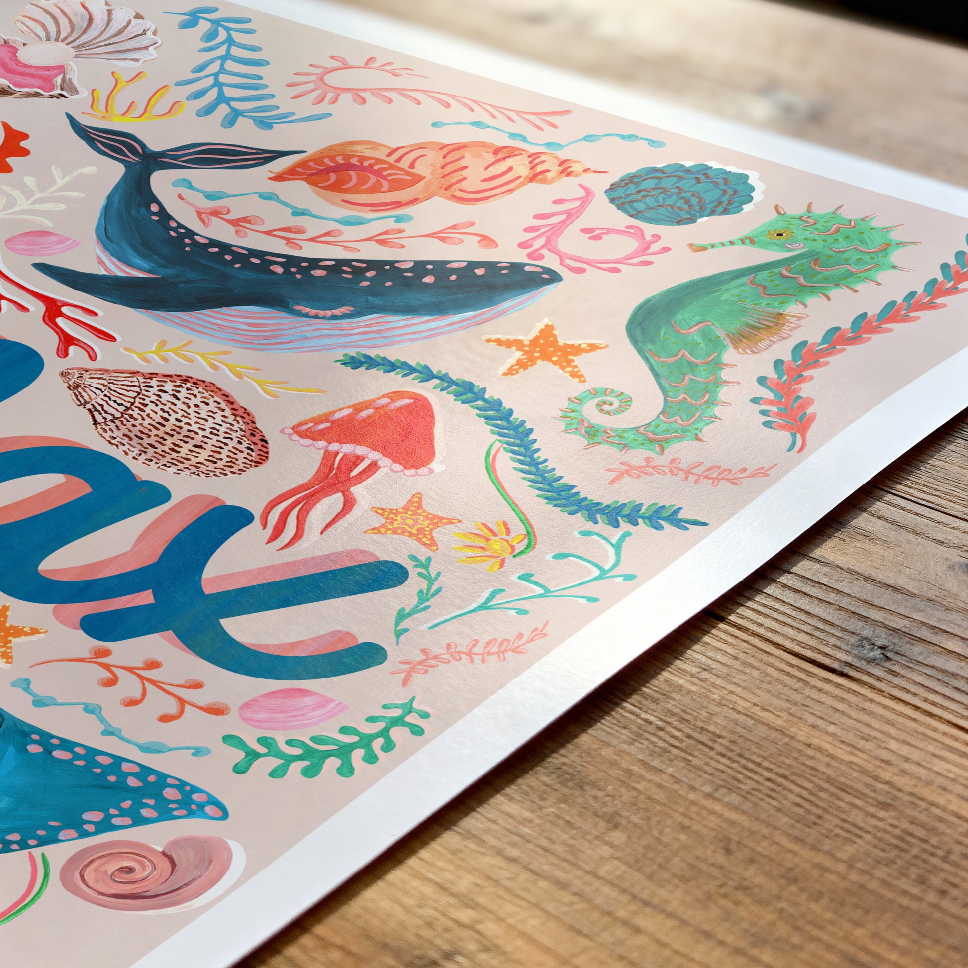 Colorful illustration of marine life on a wooden surface