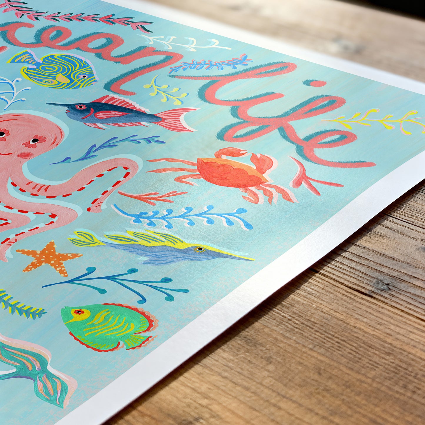 Colorful illustration of ocean life on a wooden surface