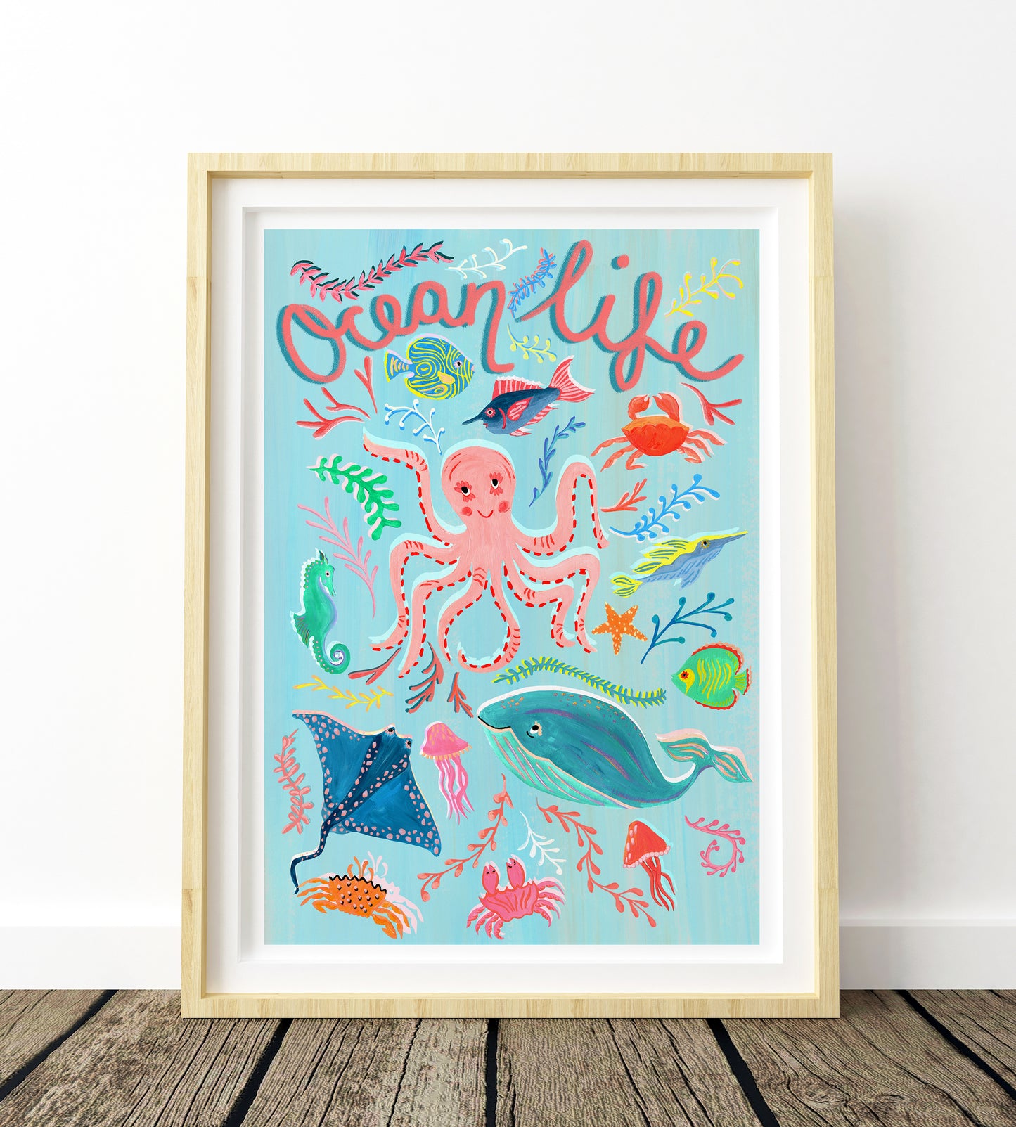 Framed artwork with ocean-themed illustrations and 'Ocean Life' text on a light blue background.