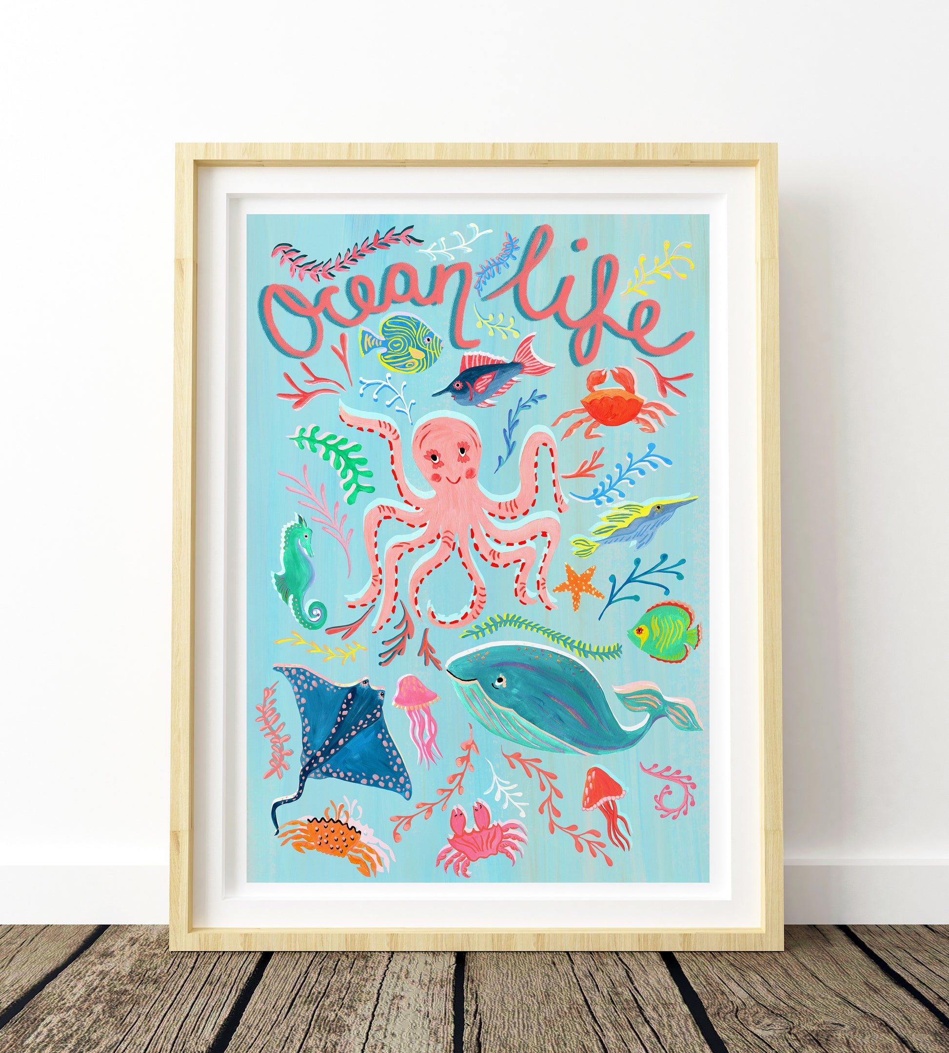 Framed artwork with ocean-themed illustrations and 'Ocean Life' text on a light blue background.