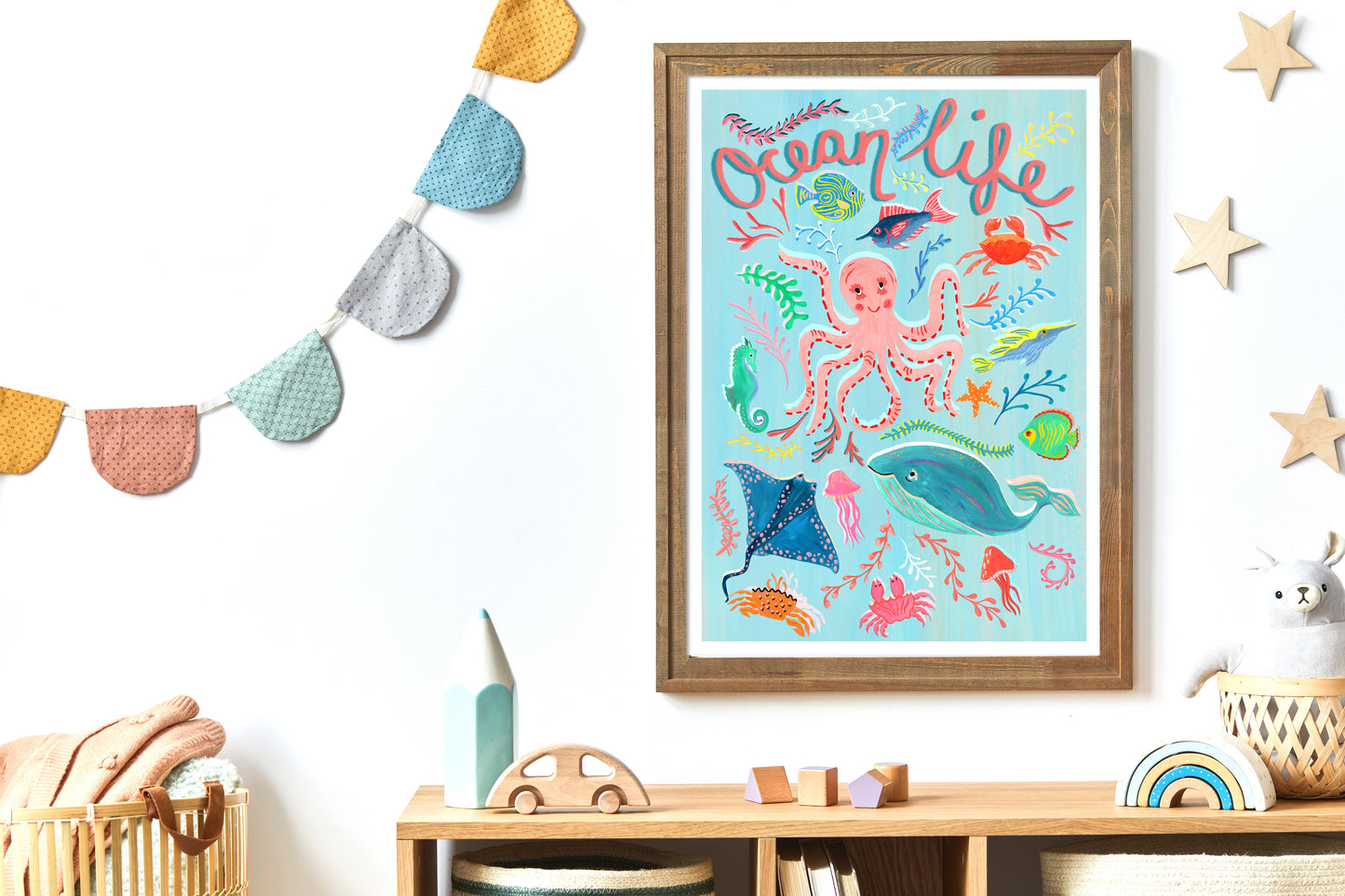 Framed 'Ocean Life' print on a wall with decorative elements