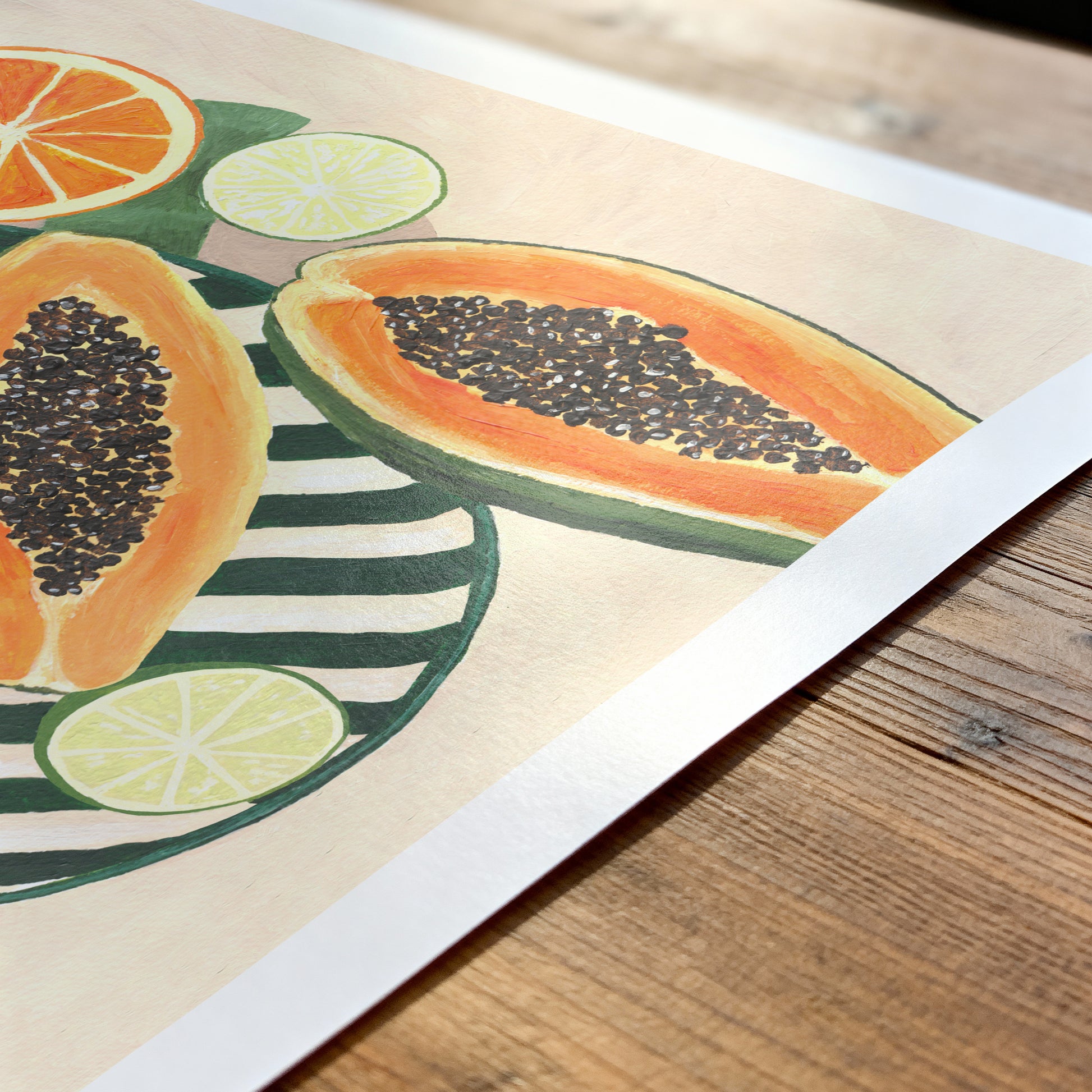 Illustration of papayas, oranges, and limes on a striped plate with a wooden surface underneath.