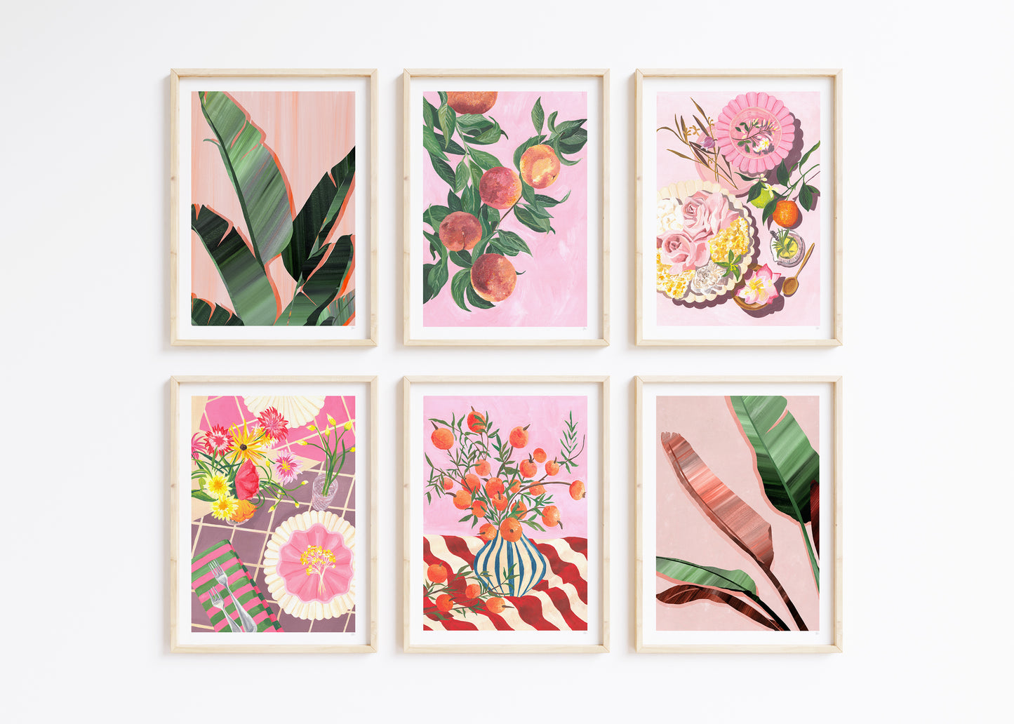 a set of 6 framed artworks of tropical leaves fruit and still life food tablescapes on a pink and green colour palette