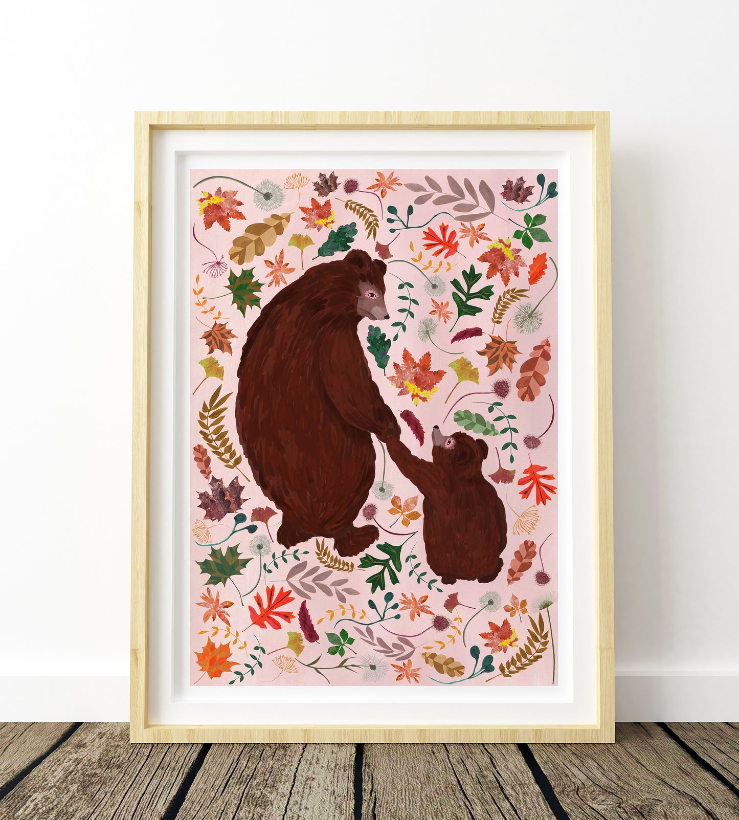 Framed artwork of two bears surrounded by colorful leaves on a pink background.