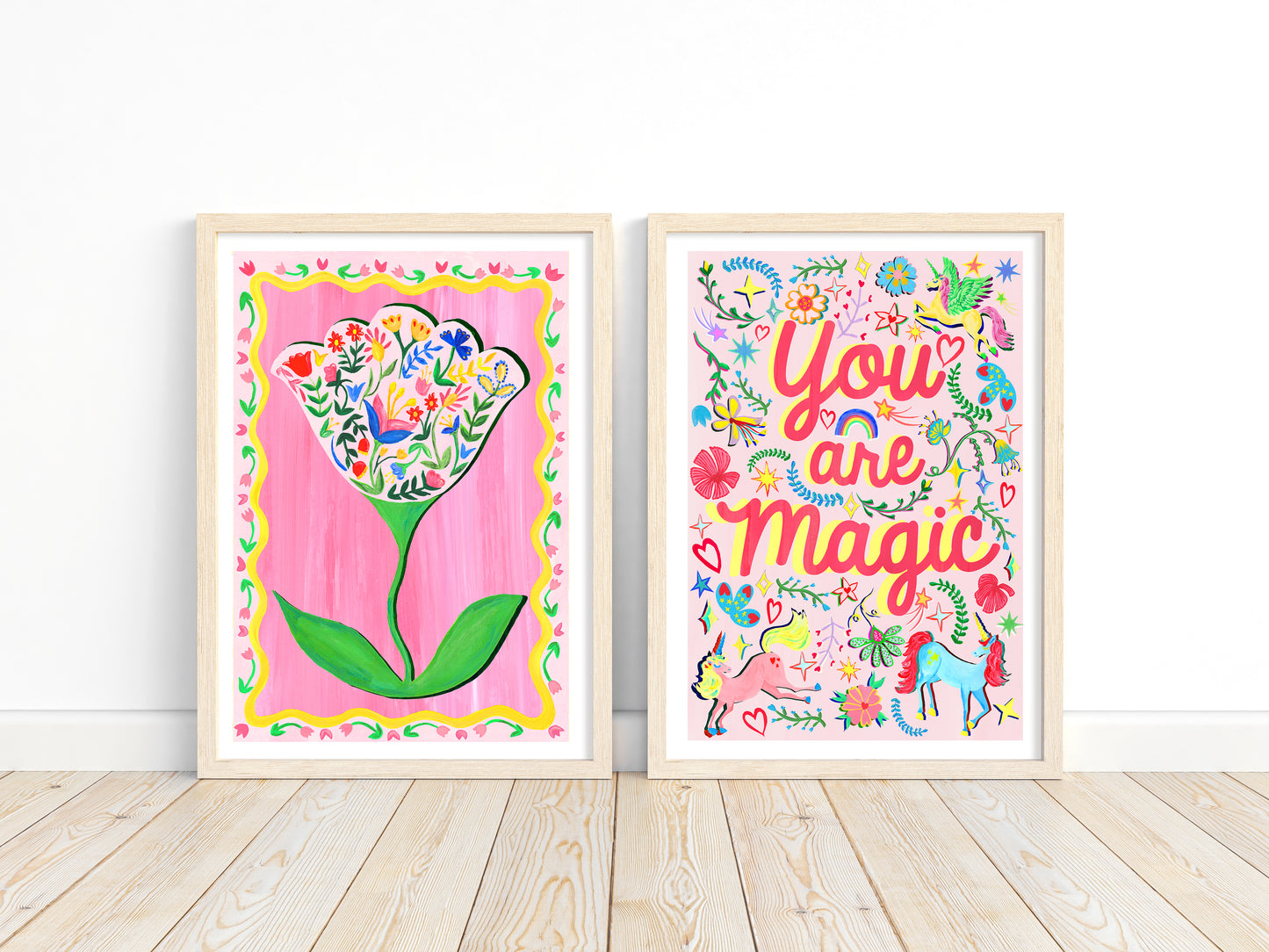 Two colorful framed artworks on a white wall.