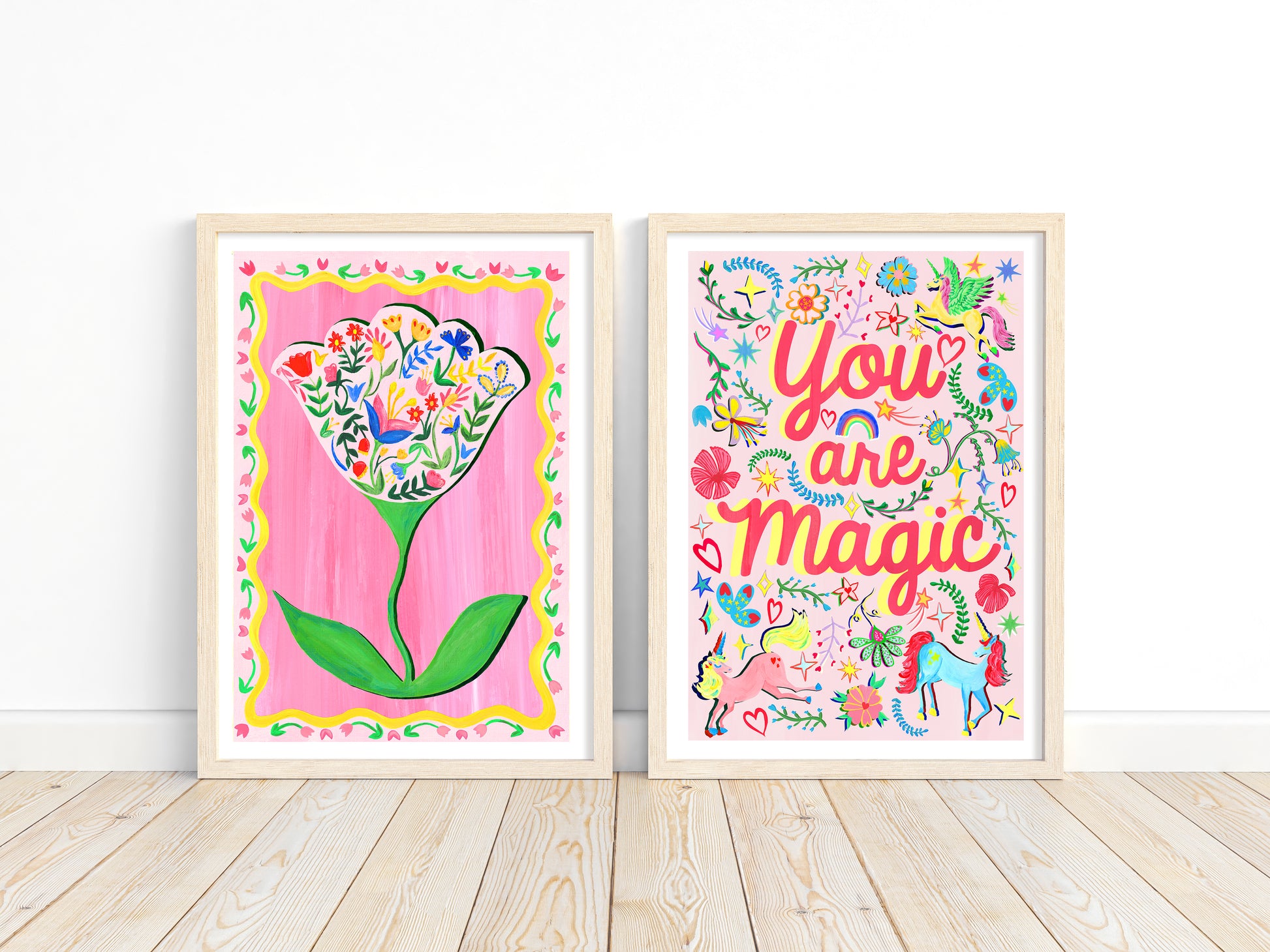 Two colorful framed artworks on a white wall.