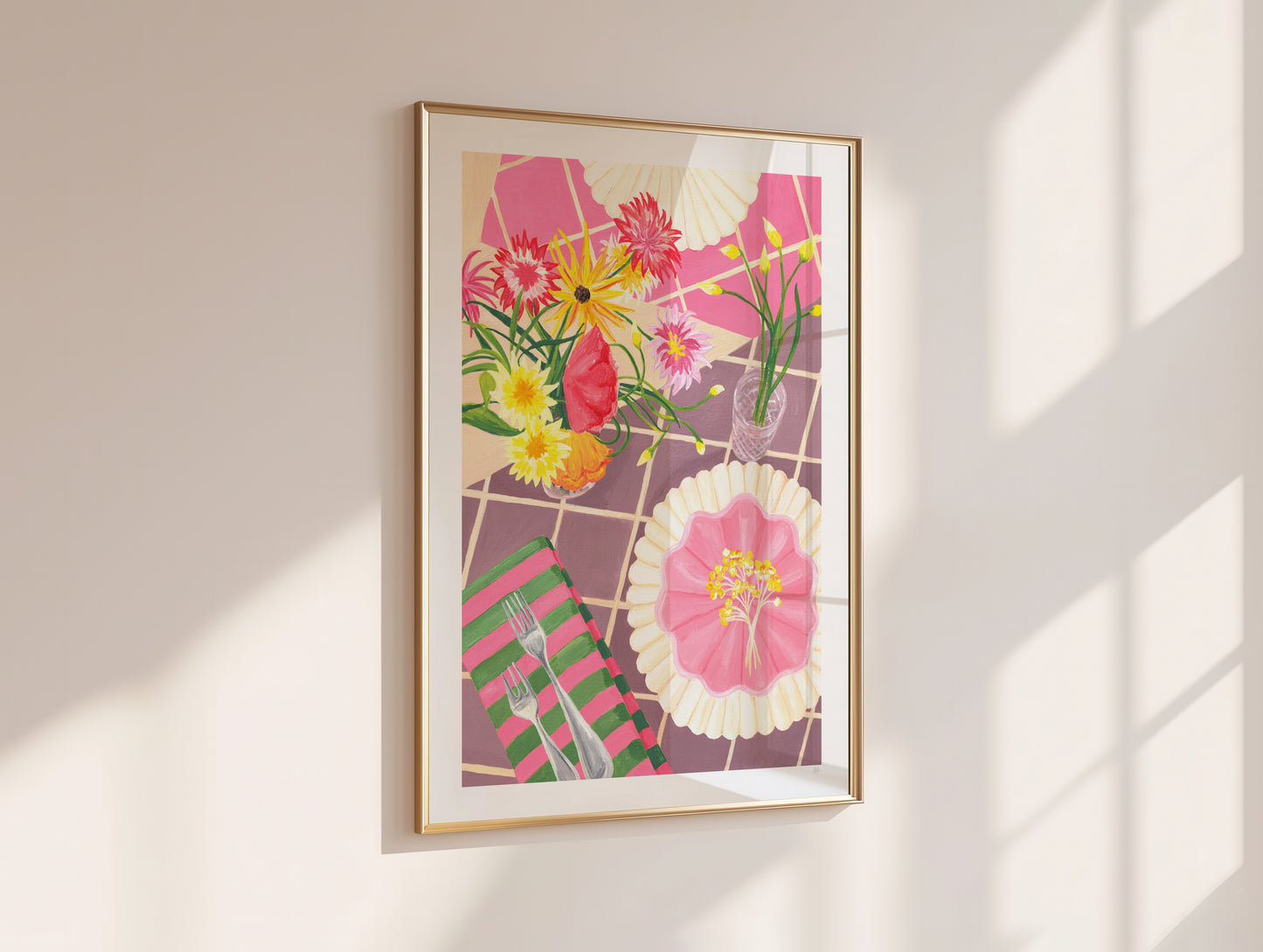 Framed floral artwork on a wall with sunlight casting shadows