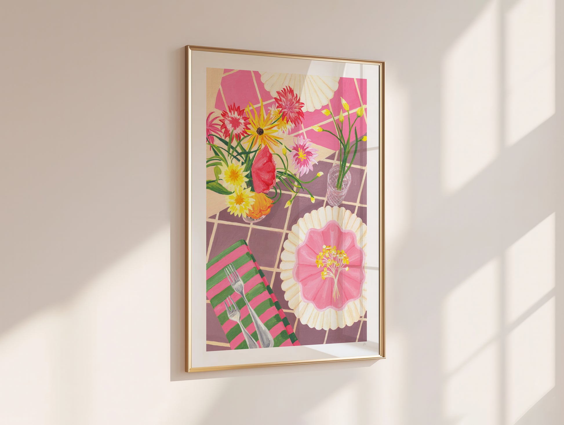 Framed floral artwork on a wall with sunlight casting shadows
