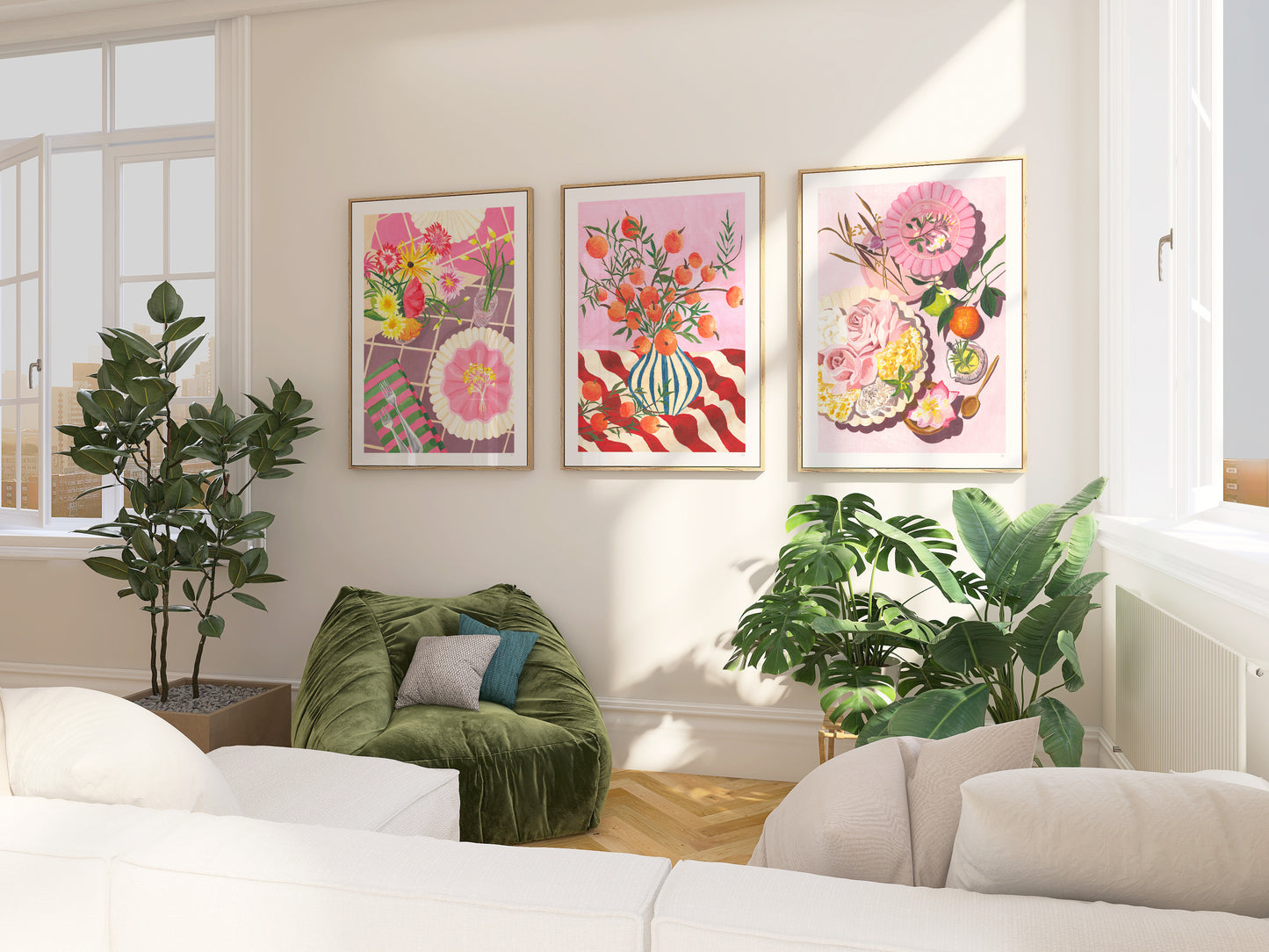 a light living room with leafy green plants dispalying a set of still life prints on the wall in a pink and green colour palette