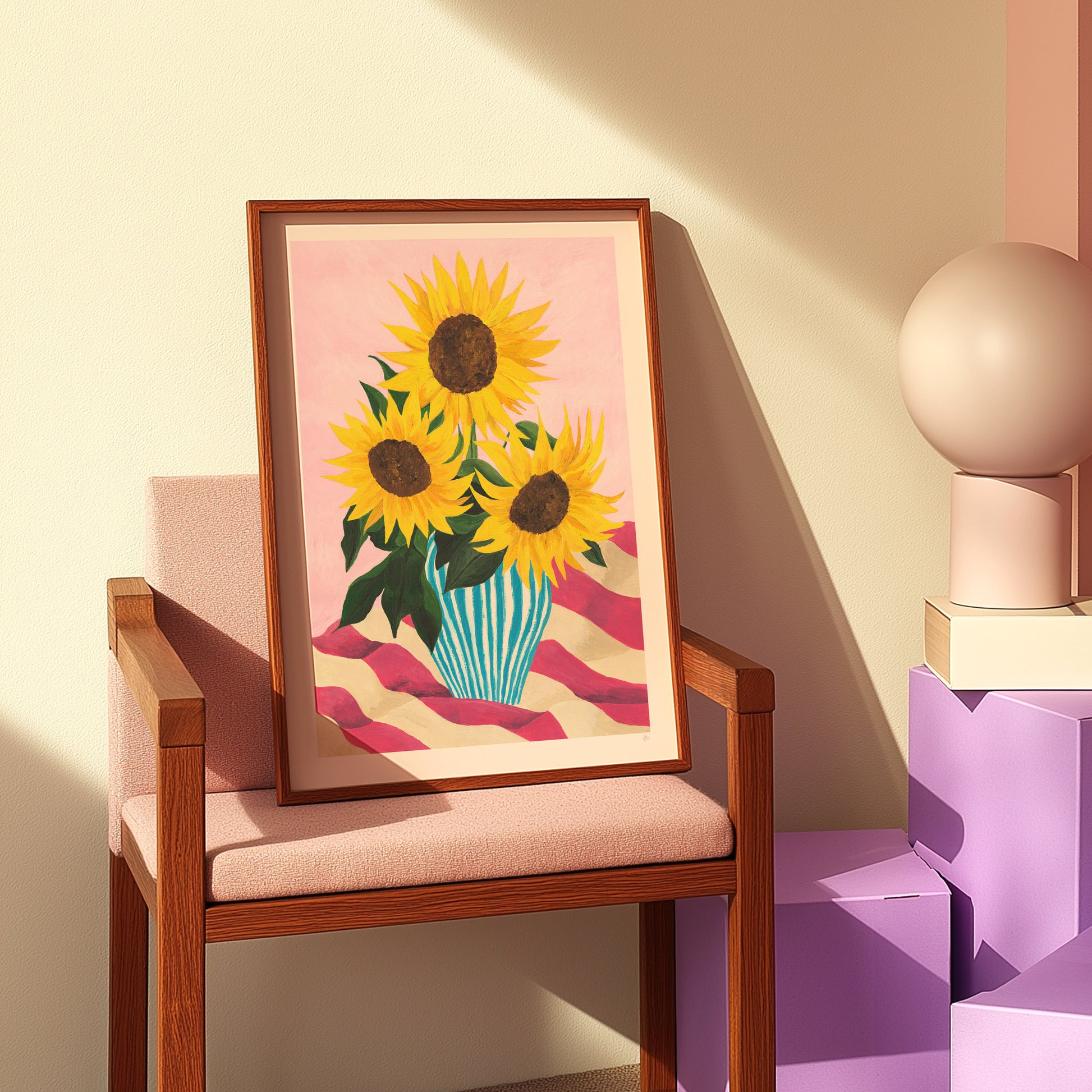 Framed artwork of sunflowers on a wooden chair against a beige wall.