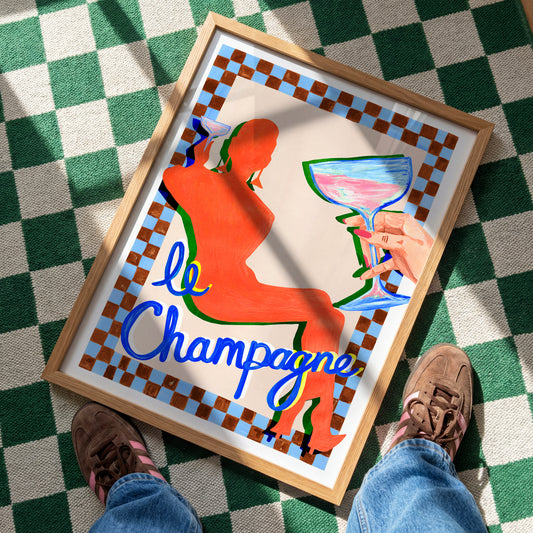 Framed artwork of a woman holding a glass with 'le Champagne' text on a checkered floor.