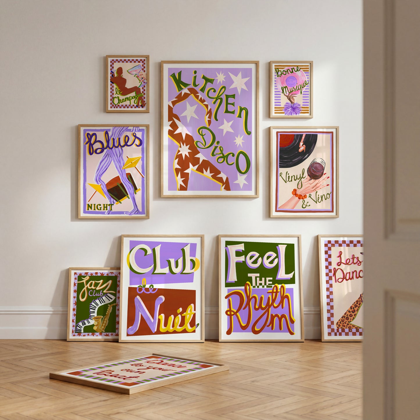 Collection of colorful wall art prints on a light-colored wall.