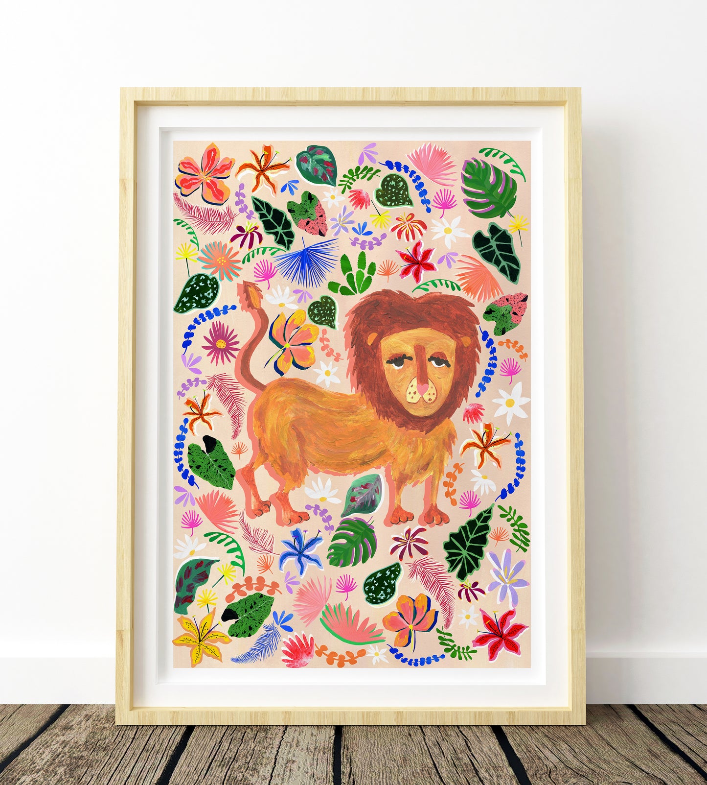 Framed artwork of a lion surrounded by colorful floral and leaf patterns on a white wall.