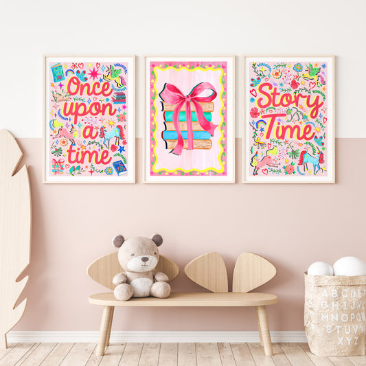 Three colorful children's posters on a wall with a wooden bench and teddy bear below.
