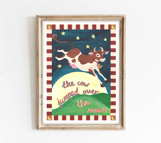 Framed children's illustration of a cow jumping over the moon with a striped border.