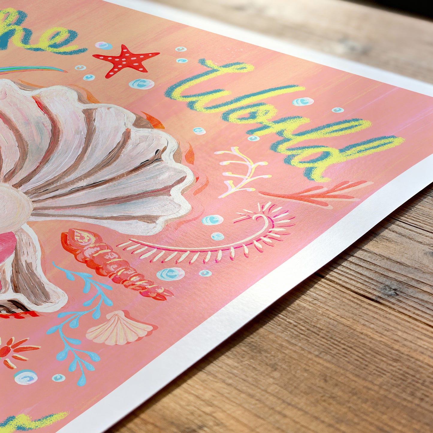 Colorful illustration of a shell and text on a wooden surface