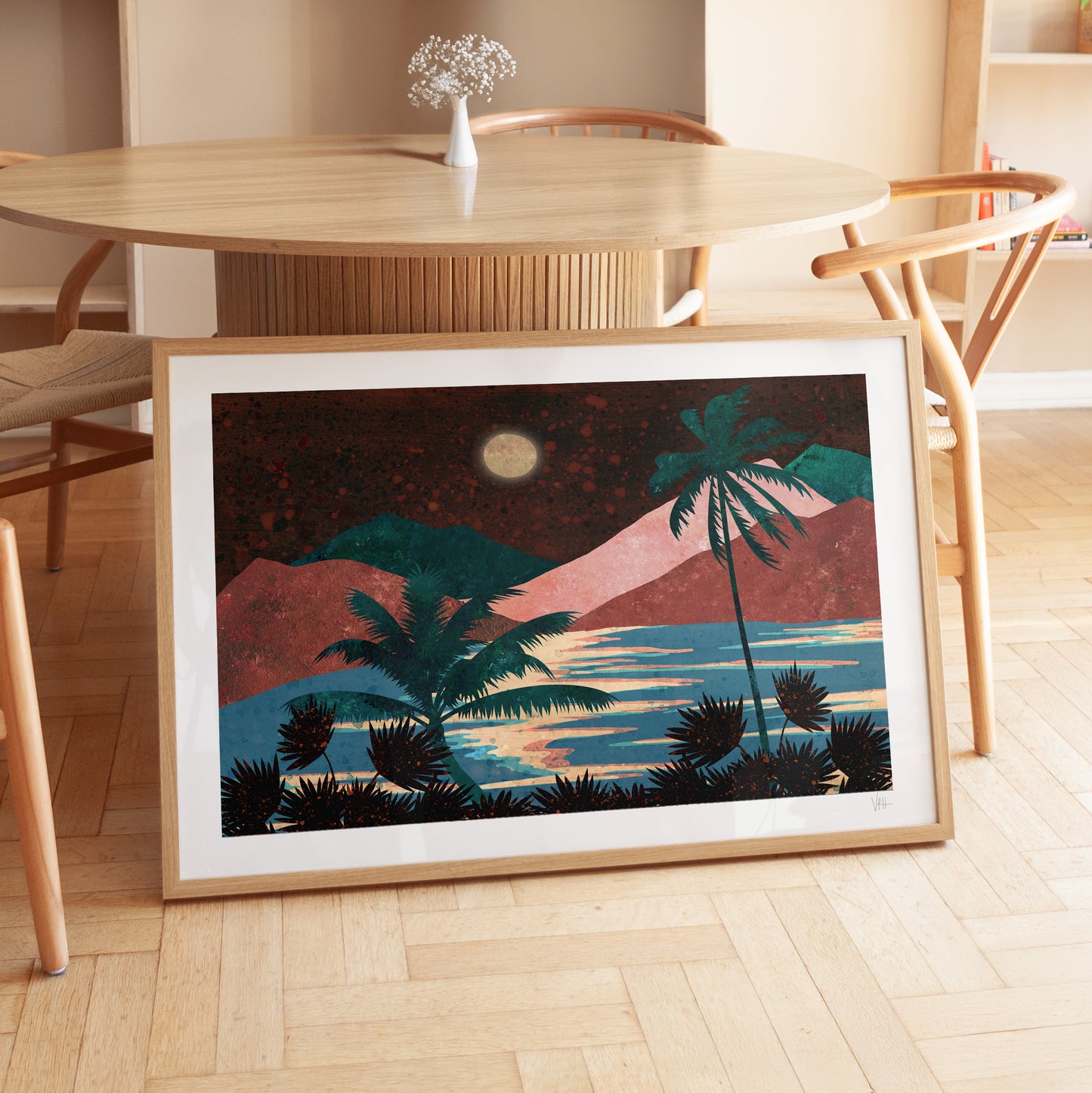 Framed artwork of a tropical landscape with palm trees and a moonlit sky, placed on a wooden floor.