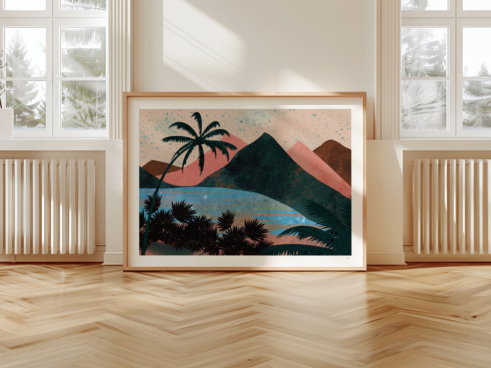 Framed artwork of a tropical landscape with palm trees and mountains in a room with large windows.