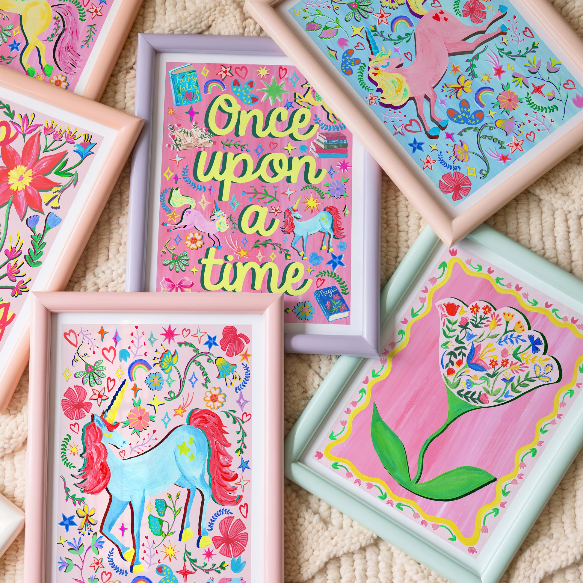 Colorful children's artwork featuring unicorns and floral designs on a textured surface.