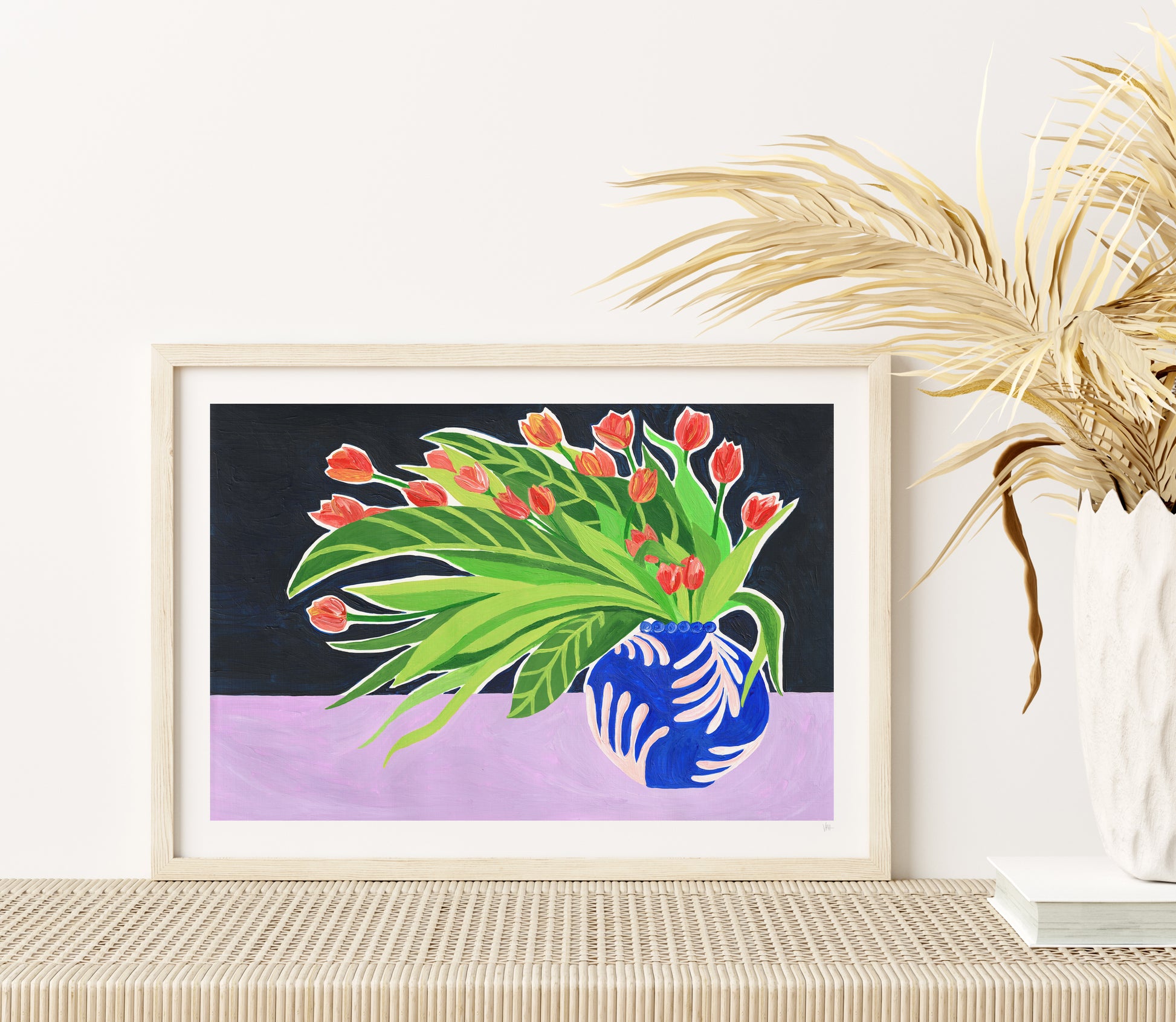 Framed artwork of a vase with flowers on a table