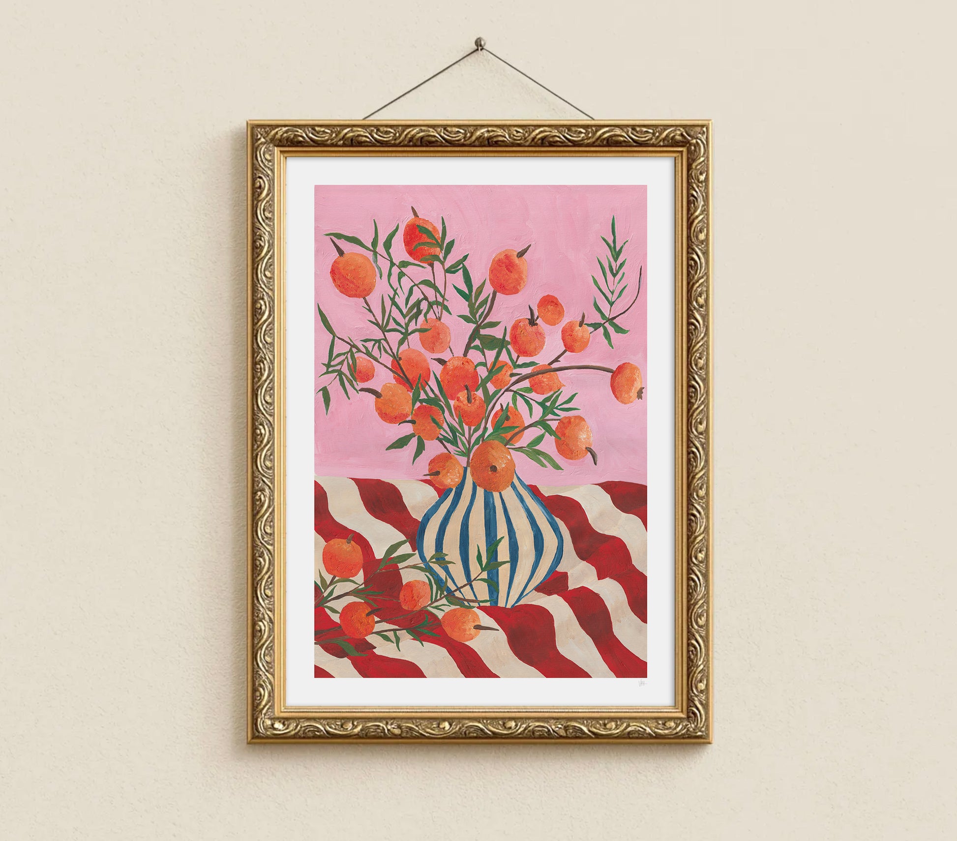 Framed artwork of a vase with flowers on a pink background, hanging on a beige wall.