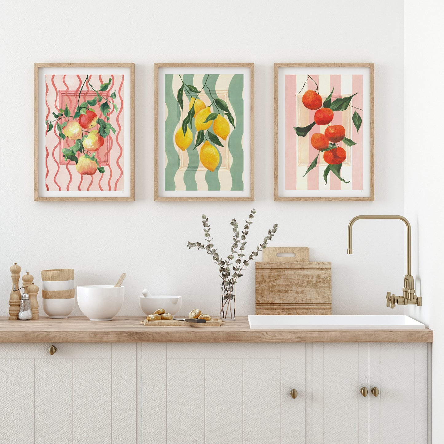 a country style kitchen with a set of 3 fruit prints of apples, lemons, oranges
