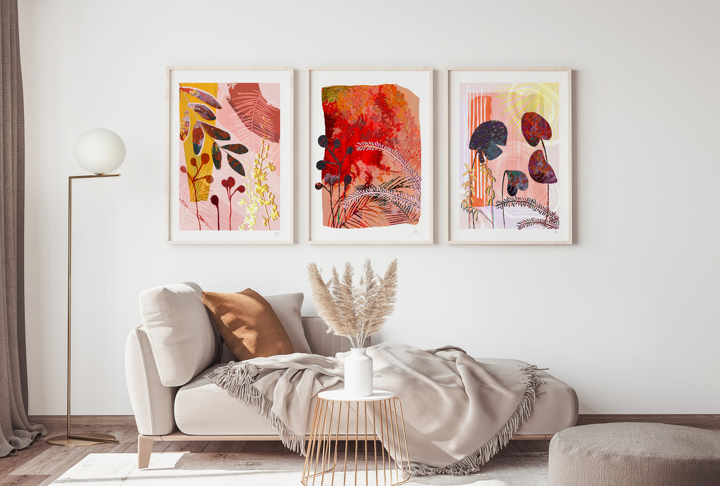 Living room with a white sofa, decorative pillows, and three colorful abstract paintings on the wall.