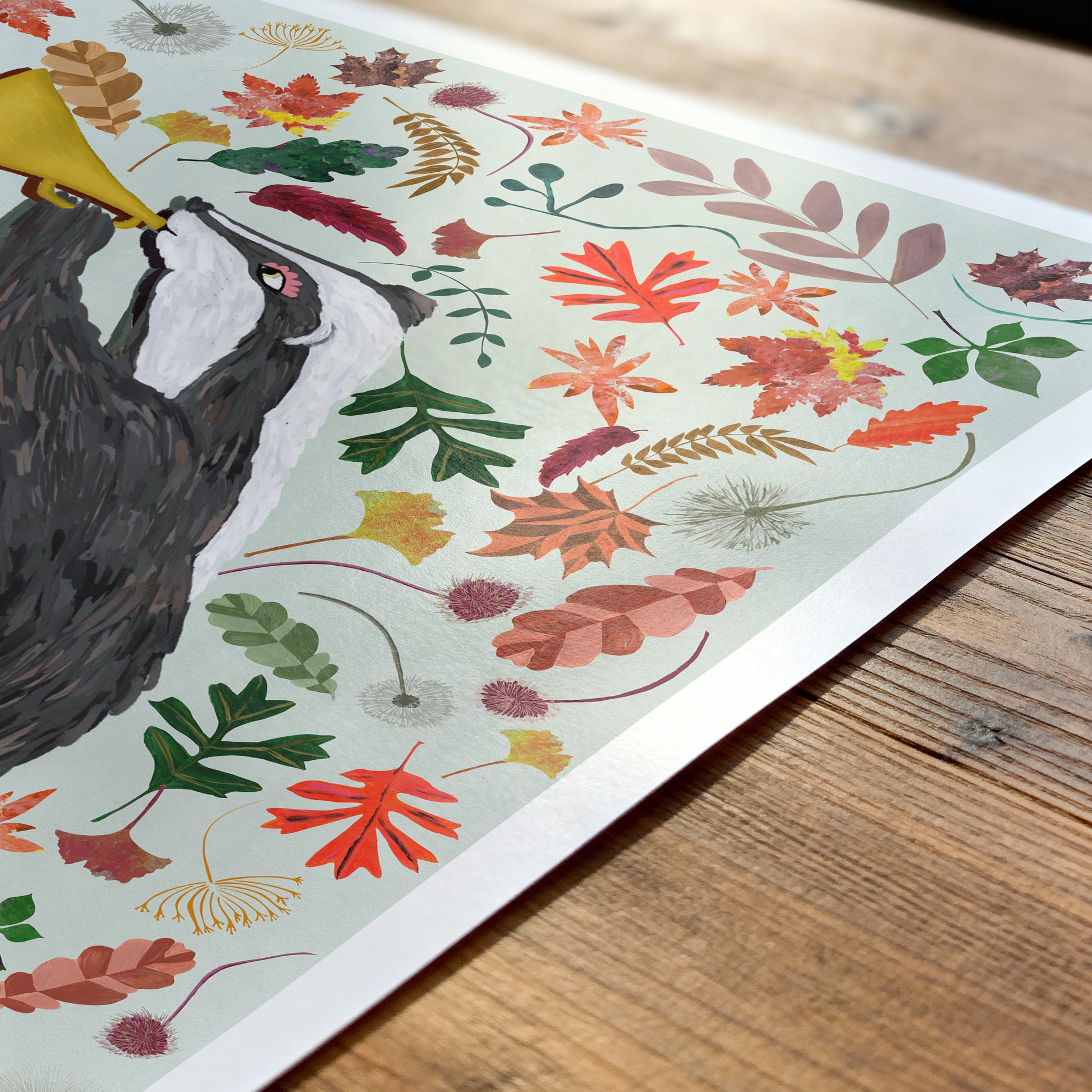 Illustration of a bird and colorful leaves on a wooden surface