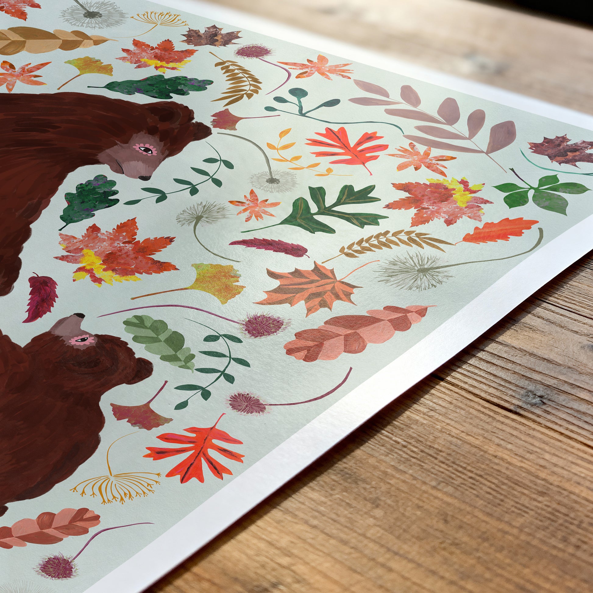 Sheet of paper with bear and leaf pattern on a wooden surface